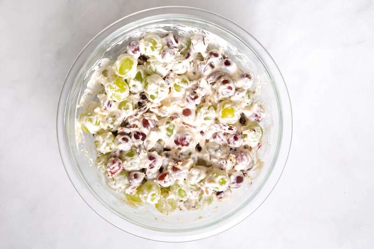 Creamy grape salad in mixing bowl.