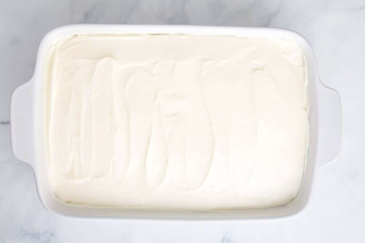 Frosted lemonade cake in baking dish.