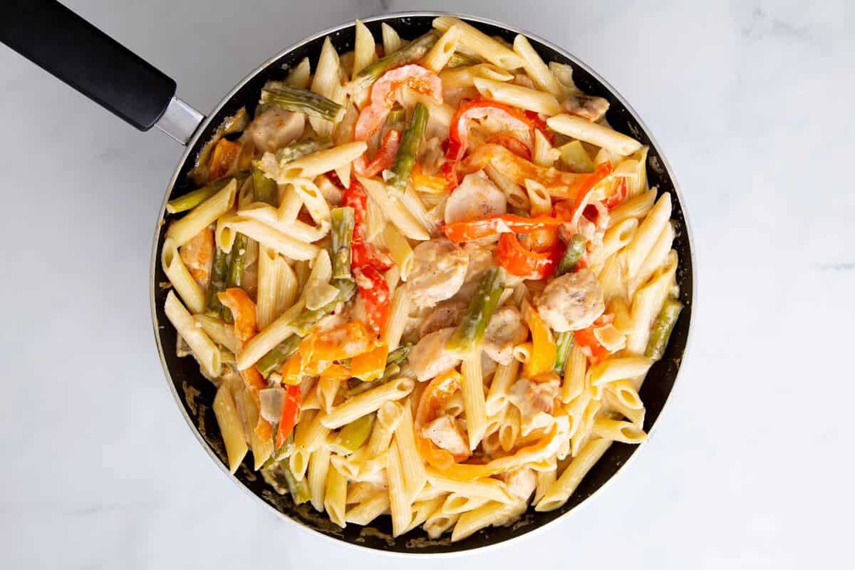 Creamy chipotle chicken pasta in skillet.