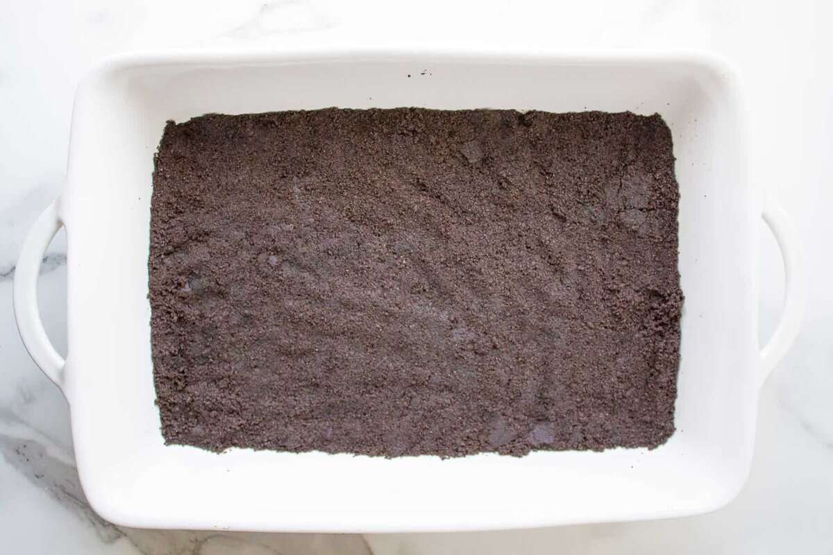 Oreo crust in casserole dish.