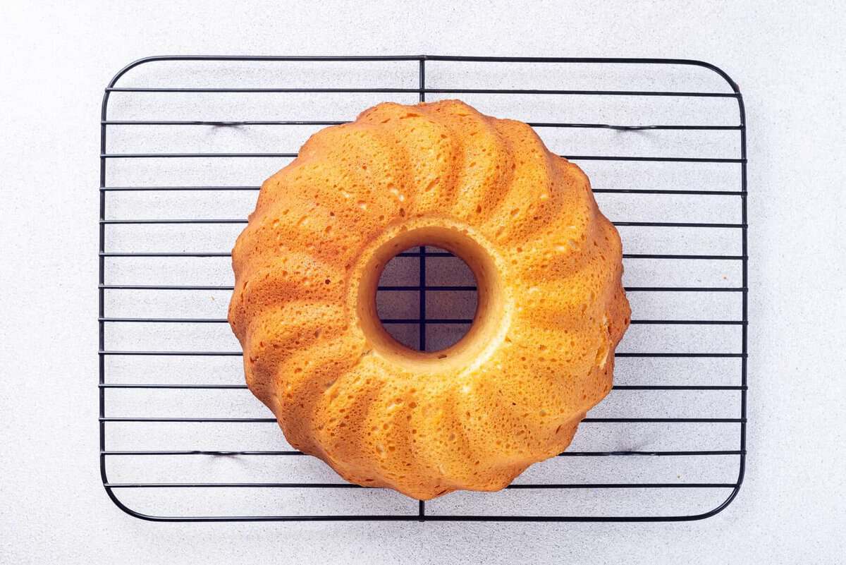 Lemon bundt cake on wire rack.
