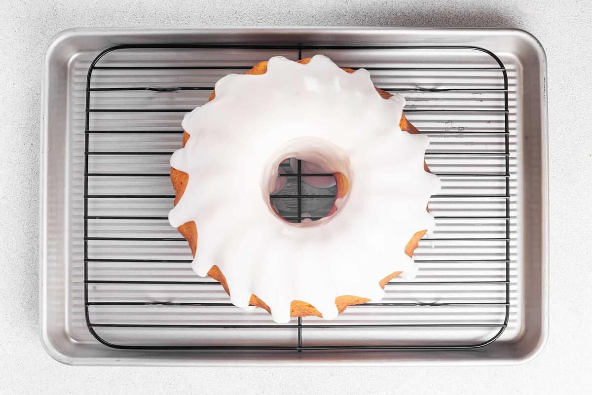 Glazed lemon bundt cake on cooling rack.