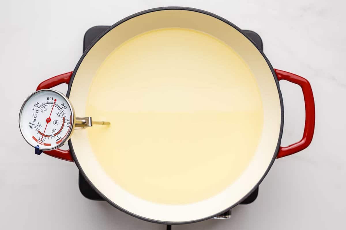 Oil in Dutch oven with thermometer.