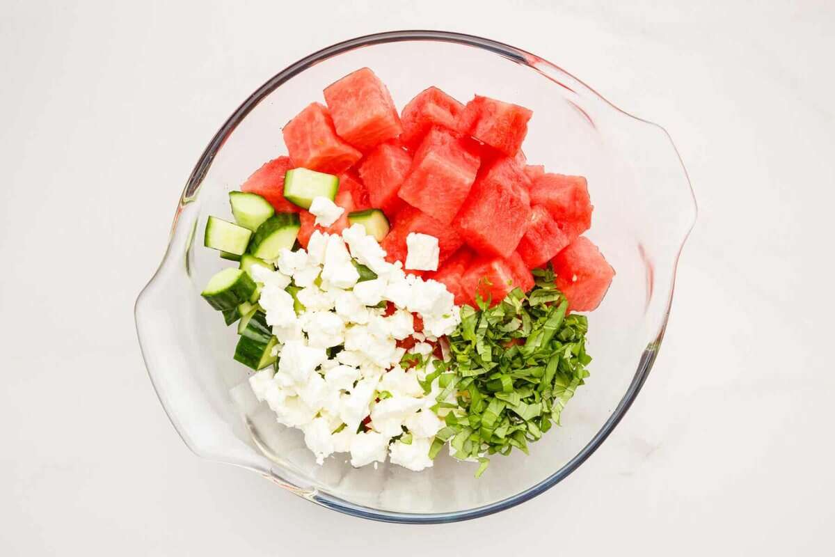 Feta, watermelon, cucumber, and mint in bowl.