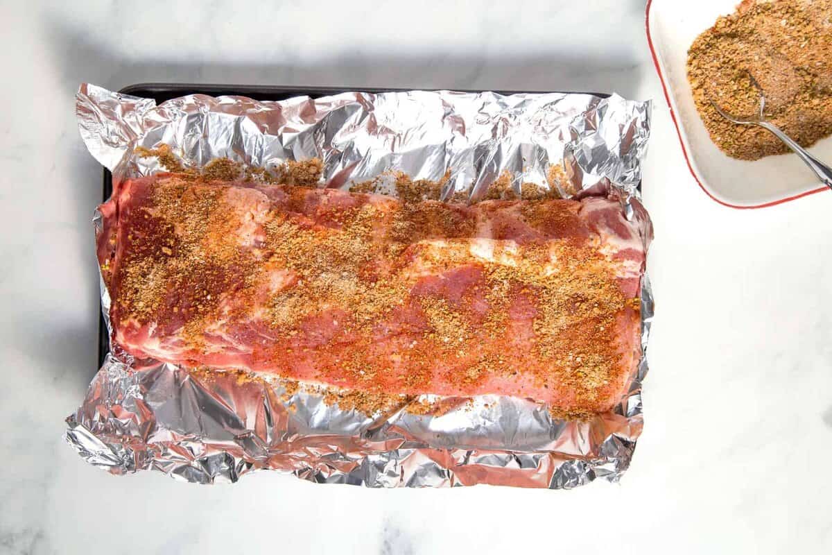Seasonings rubbed onto uncooked ribs.