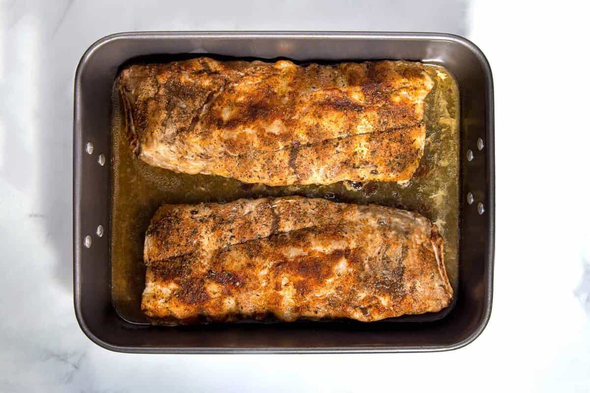 Baked BBQ ribs on sheet pan.