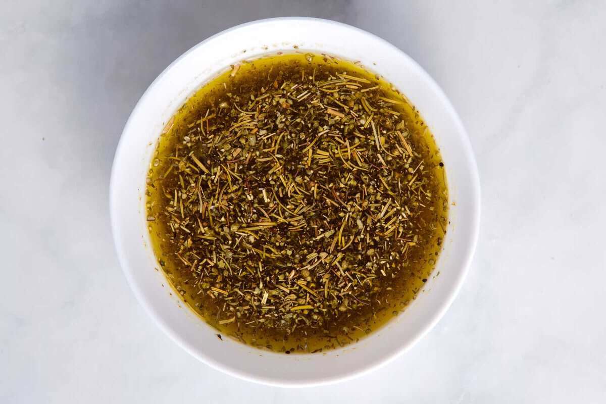 Bread dipping oil in bowl.