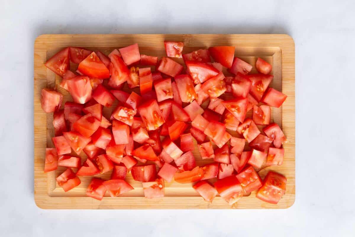 Chopped tomatoes on wood board.