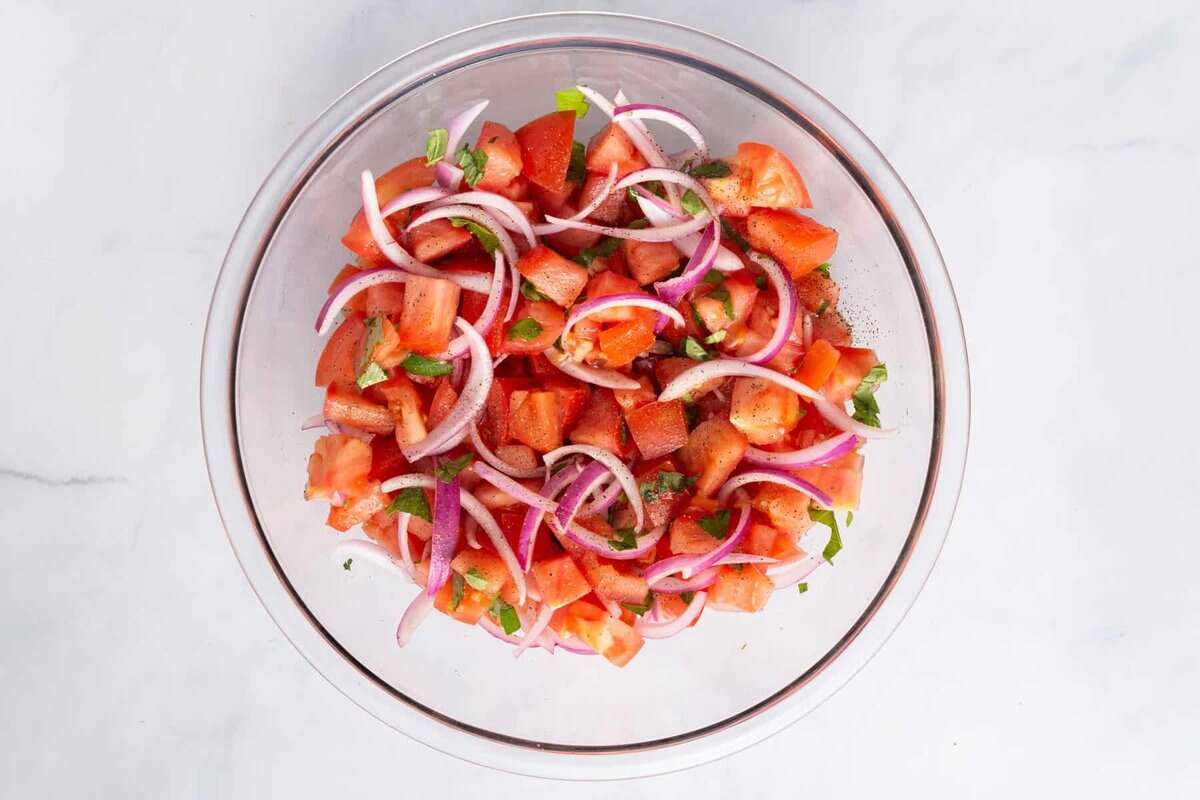 Bowl of tomato and onion salad.