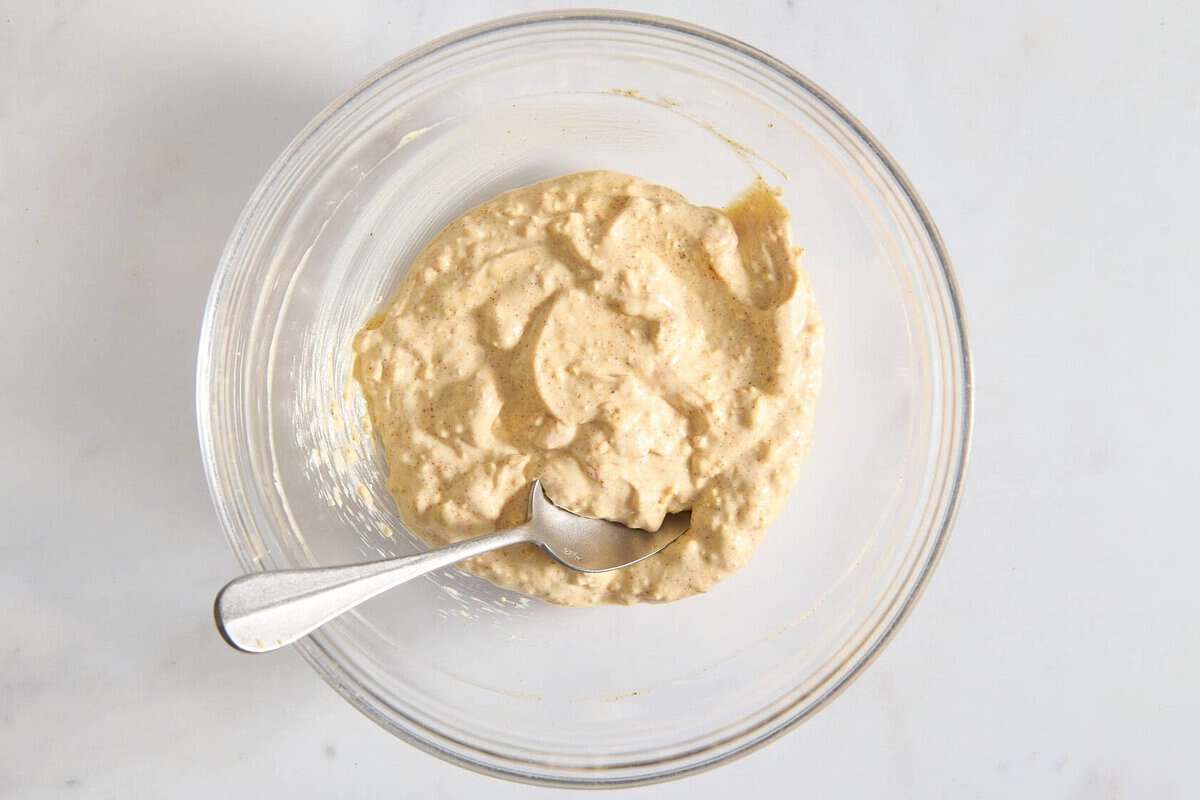 Dressing for deviled egg pasta salad in bowl.