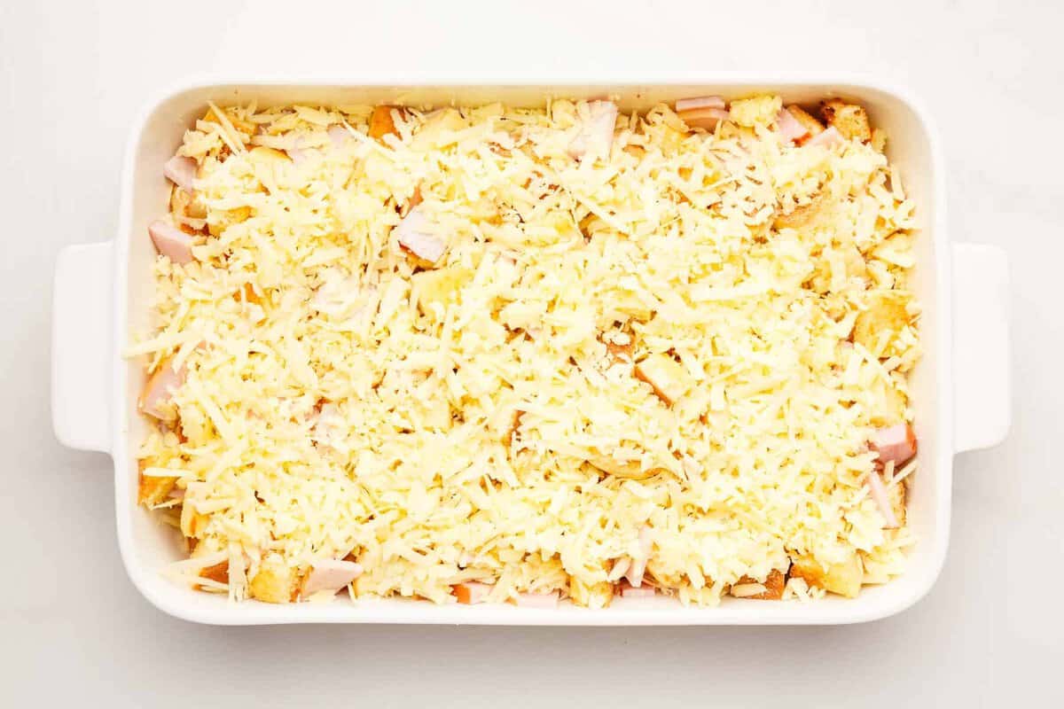 Eggs benedict casserole in baking dish before baking.