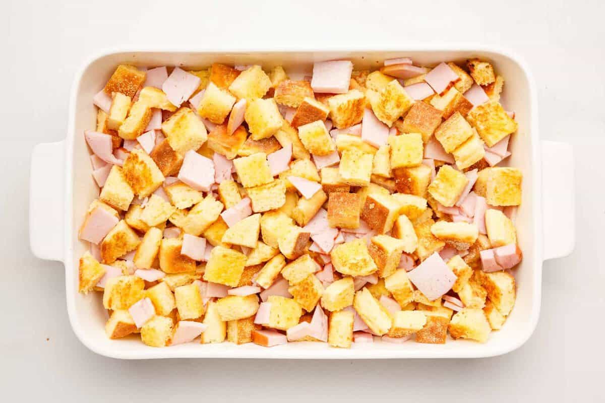 Bacon and English muffins in casserole dish.