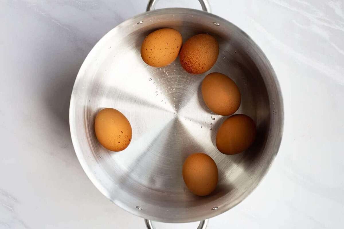 Hard boiled eggs in pot of water.