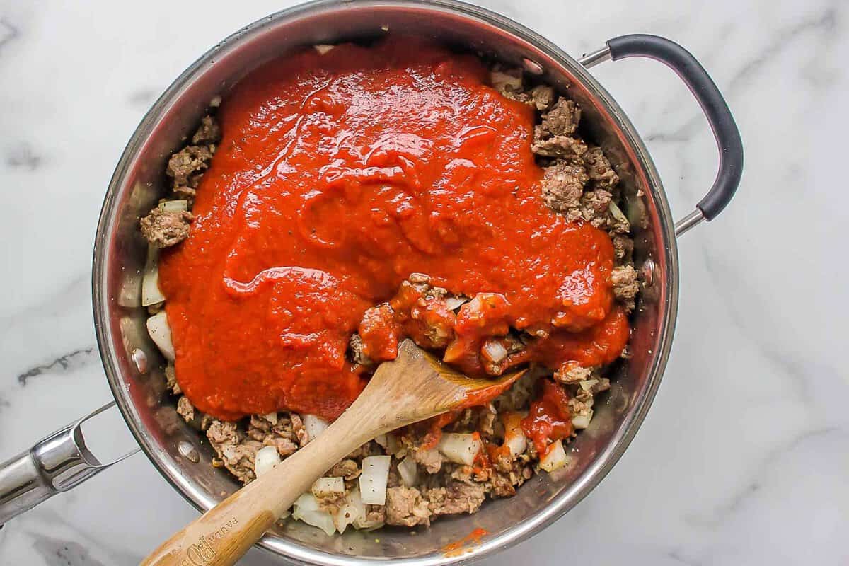 Stirring sauce into pan of browned beef.