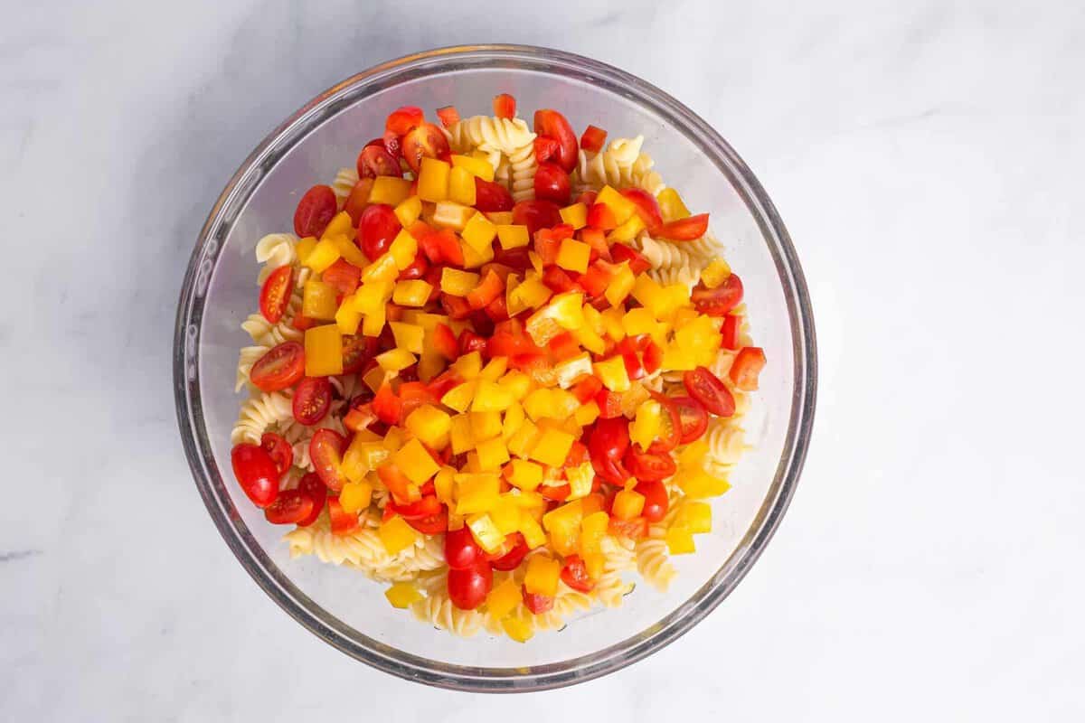 Vegetables added to bowl of rotini.