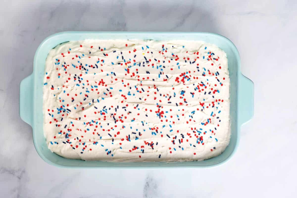 Red white and blue poke cake with cool whip topping.