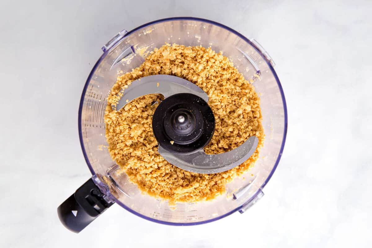 Golden oreo crumbs in food processor.