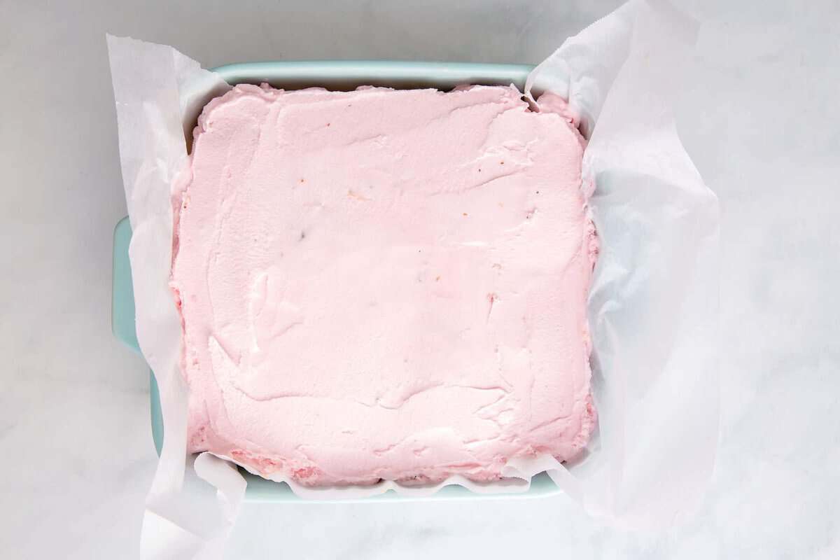Strawberry ice cream layered in pan.