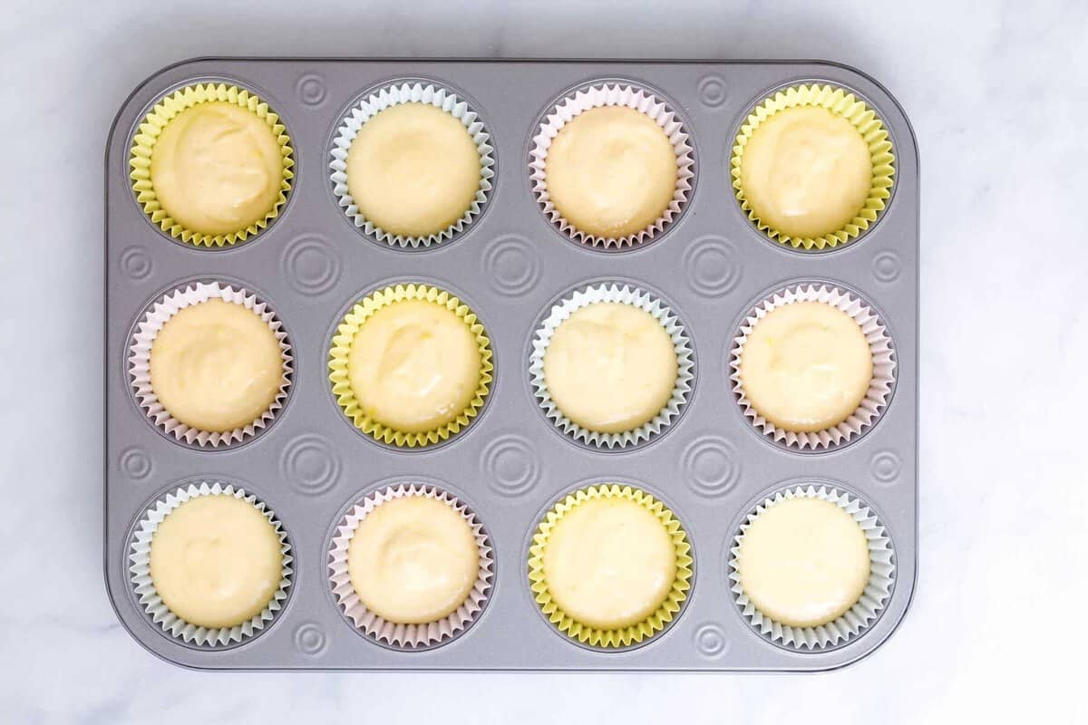 Unbaked lemon cupcakes in tin.