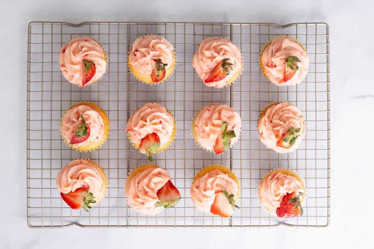 Strawberry lemon cupckaes on cooling rack.