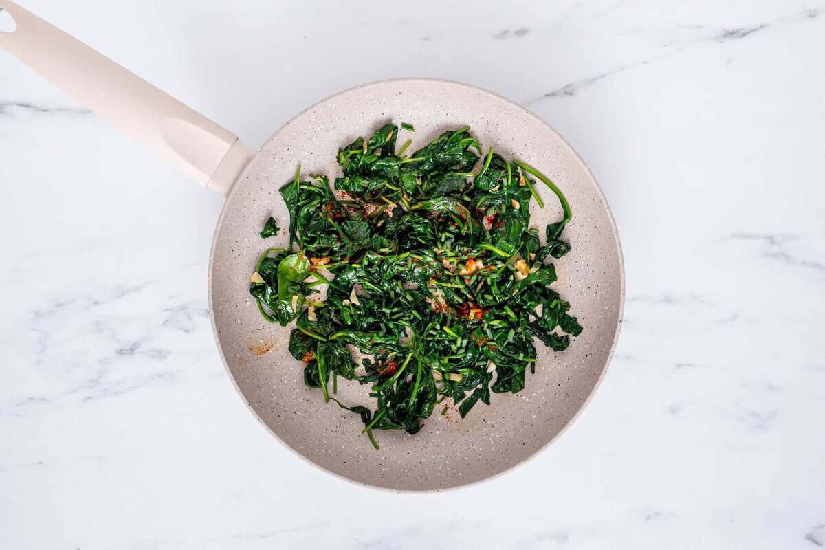 Sauteed spinach in skillet.