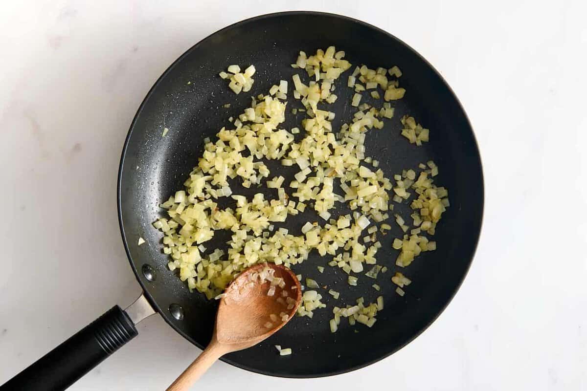 Onions cooking in skillet.