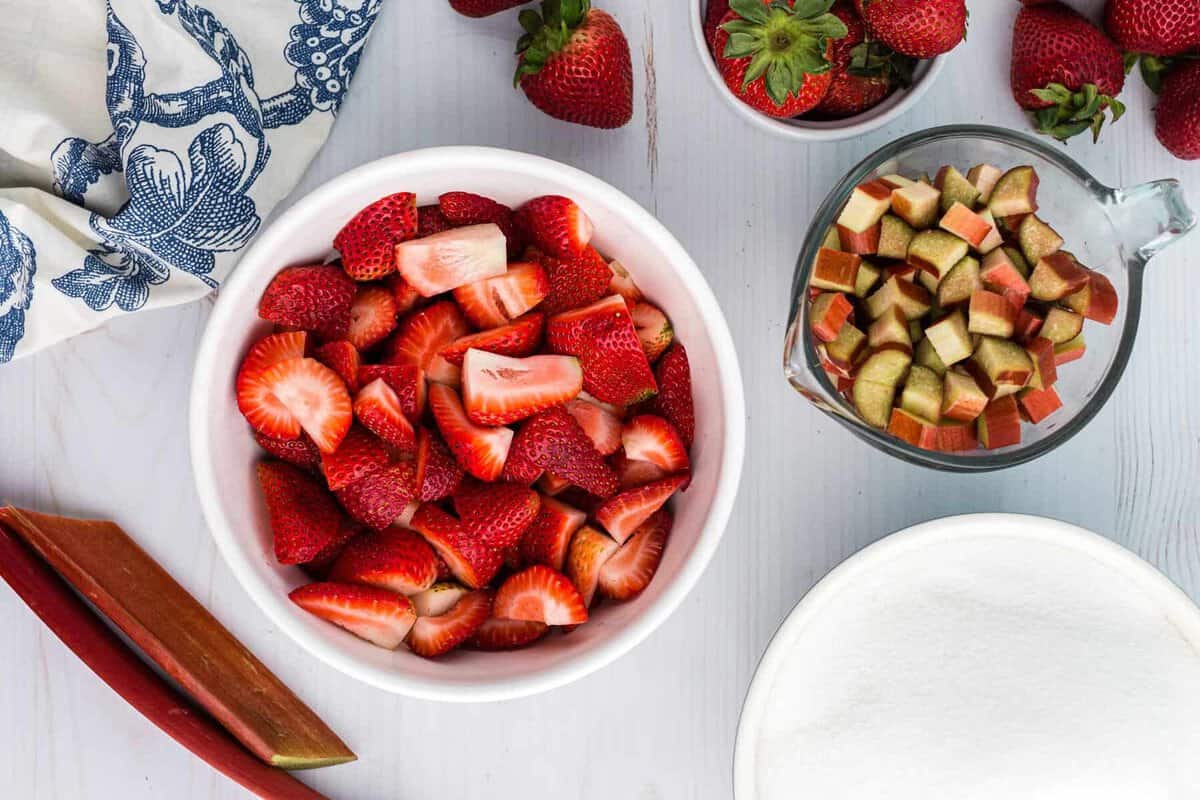 Strawberries and rhubarb in 2 bowls.
