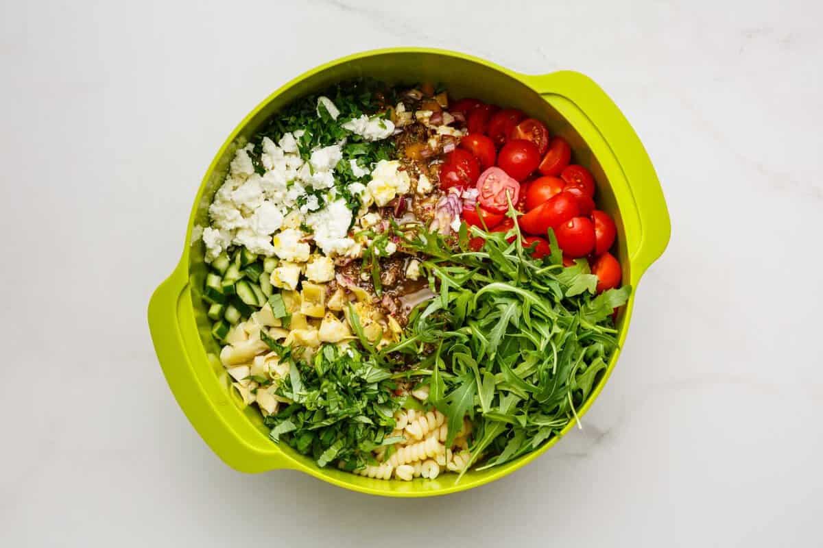 Ingredients for summer pasta salad in bowl.