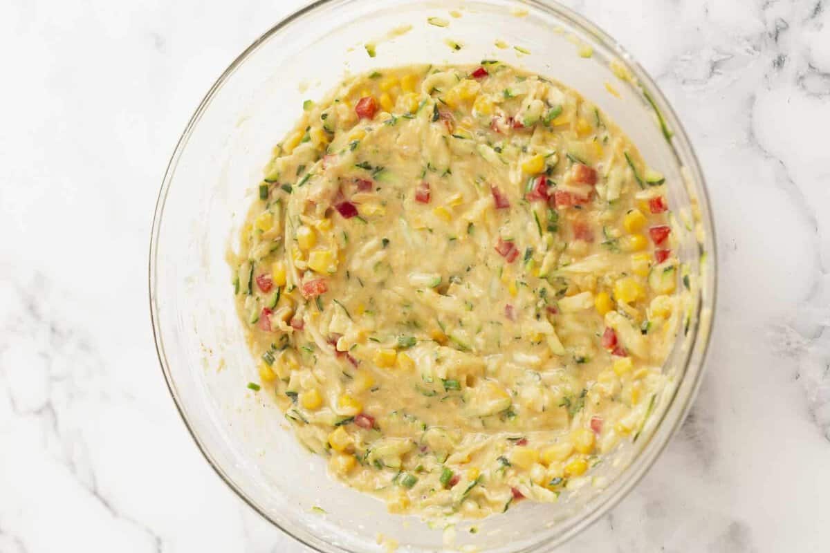 Zucchini corn fritter mixture in bowl.