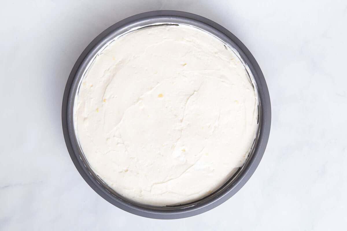 No bake cheesecake filling spread over crust.