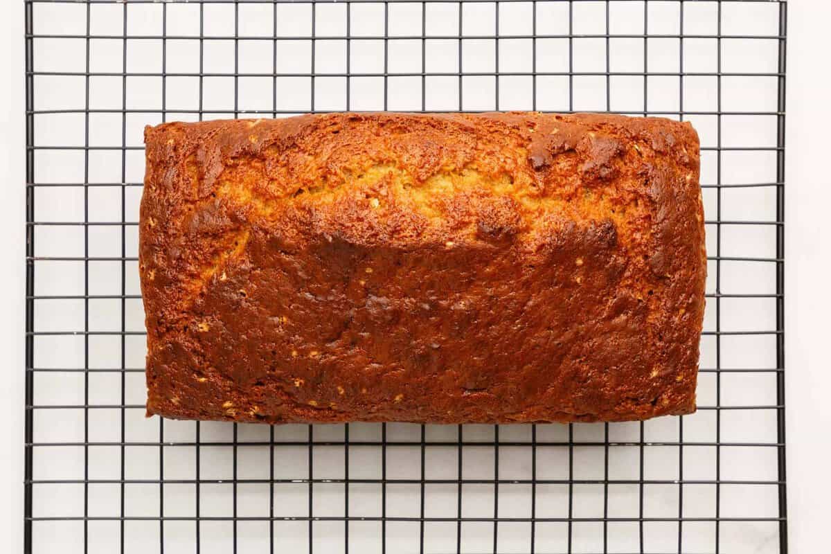 Banana zucchini bread loaf cooling on wire rack.