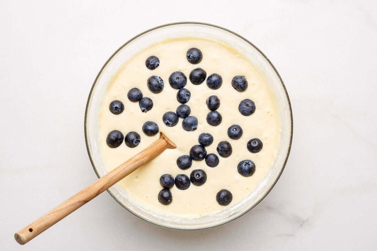 Blueberries folded into waffle batter.
