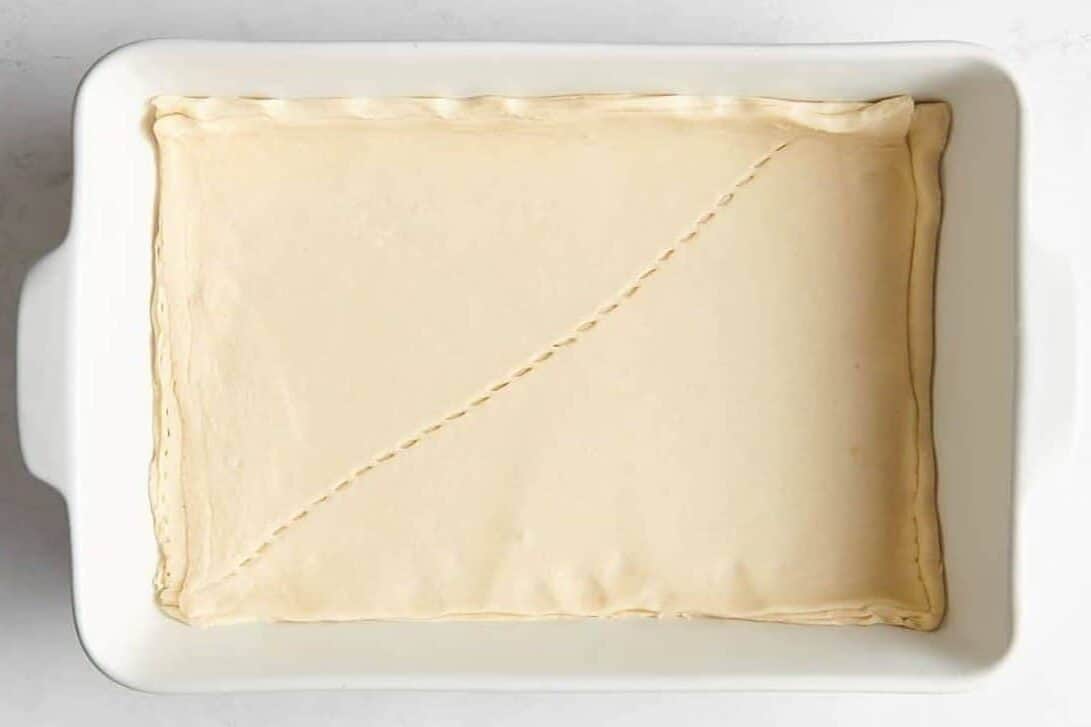 Crescent roll dough in casserole dish.