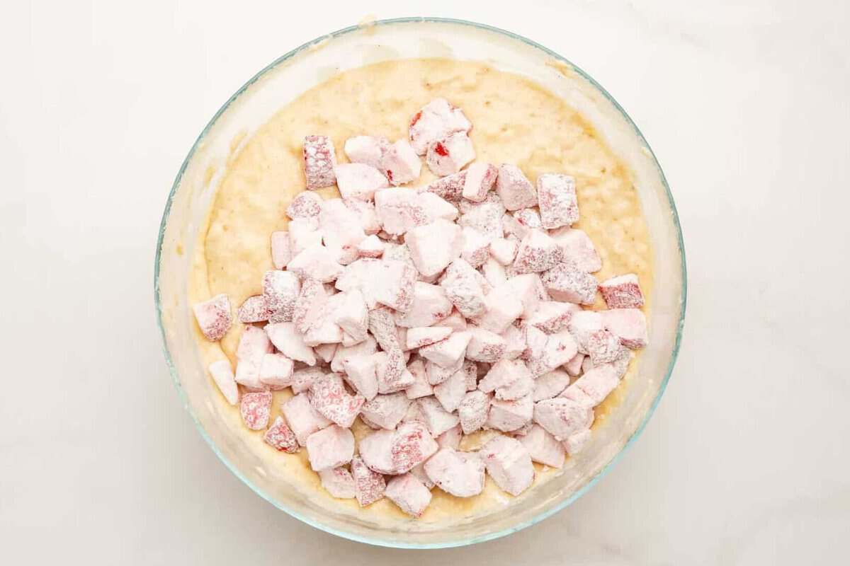 Flour-coated strawberries added to banana bread batter.