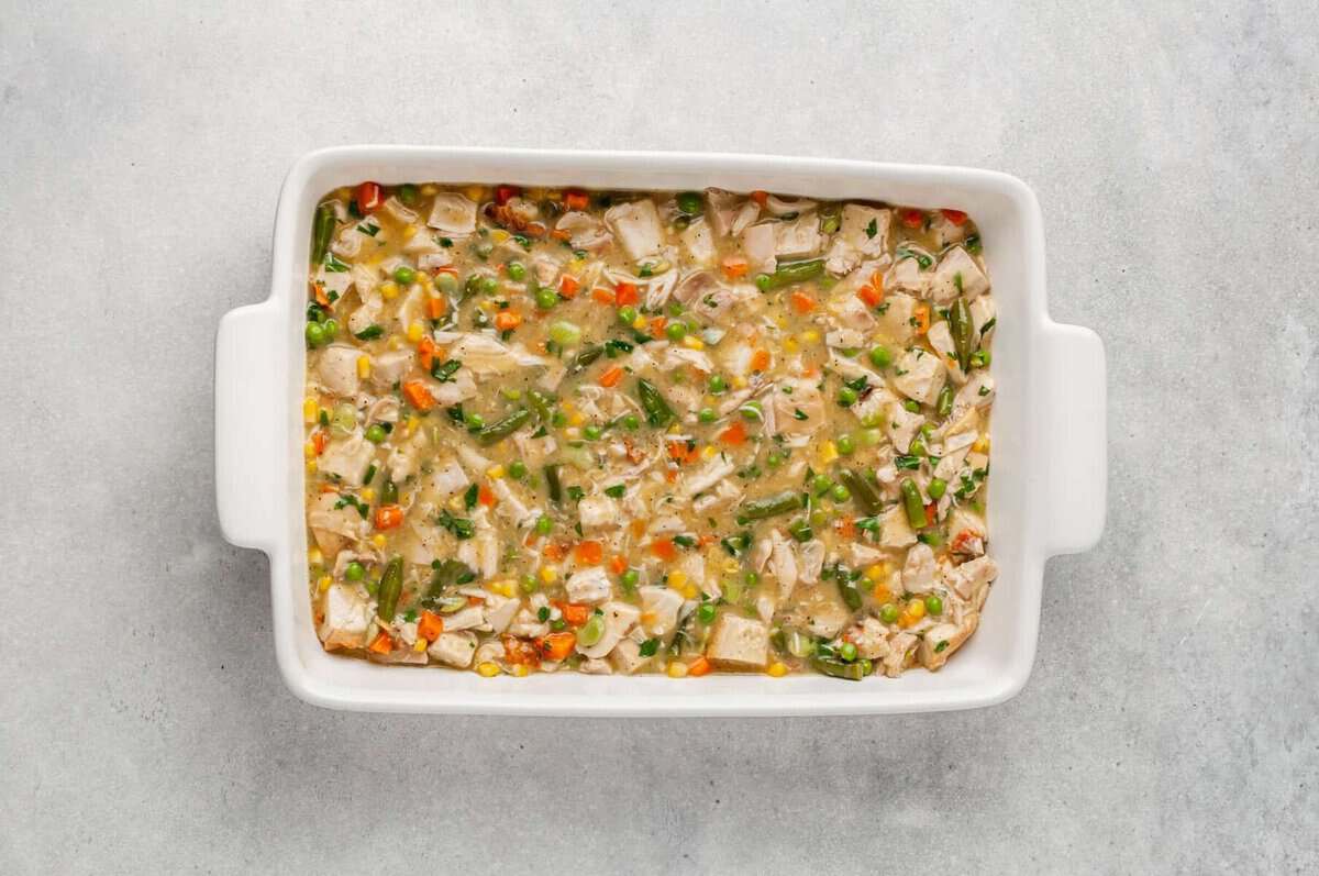 Chicken pot pie filling in casserole dish.