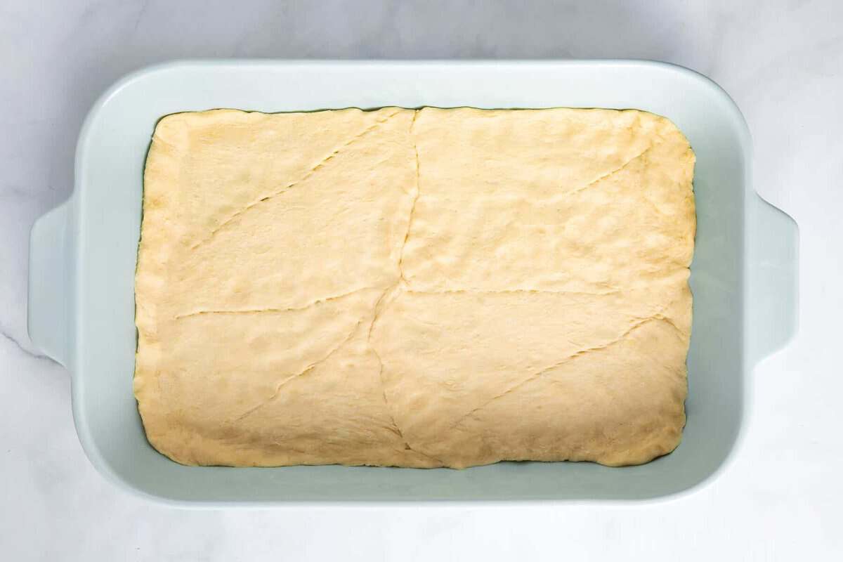 Crescent roll dough in baking dish.