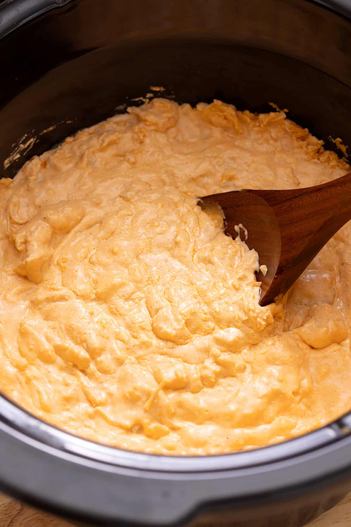 Buffalo chicken dip stirred together in a slow cooker