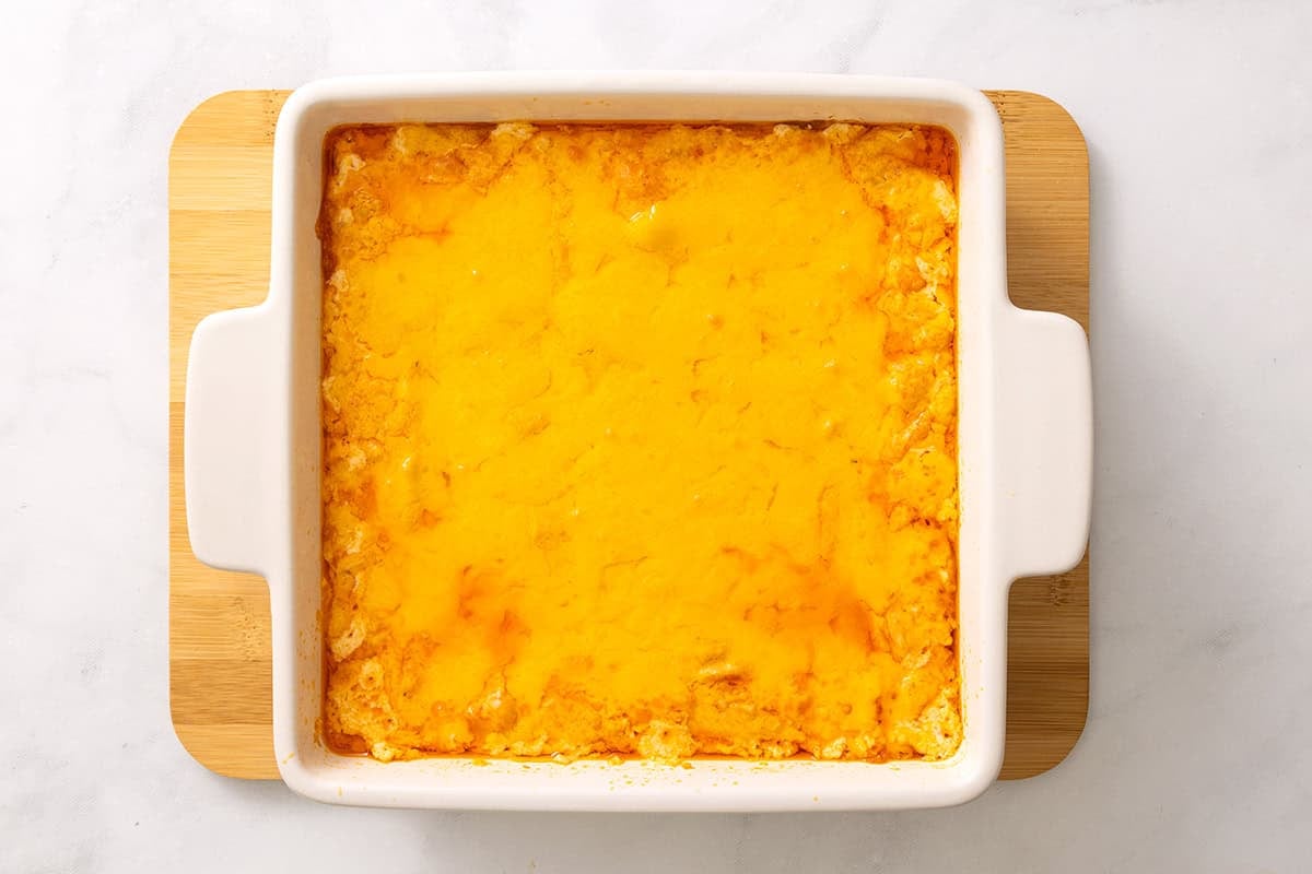 Baked buffalo chicken dip with melted cheddar, fresh from the oven.